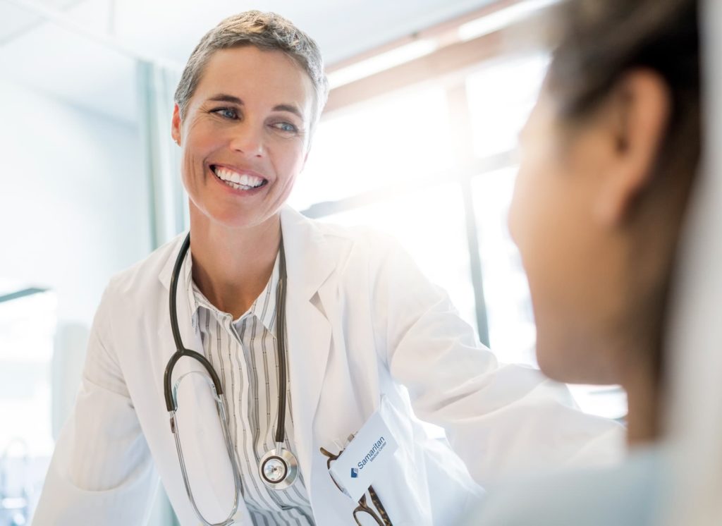 Illustrative image: caregiver reaching out to patient. 