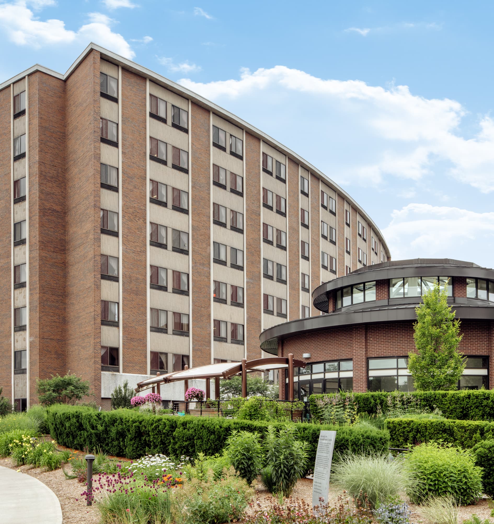 Image shows a view from Samaritan Healing Gardens with Samaritan Keep Home and the rotunda. 