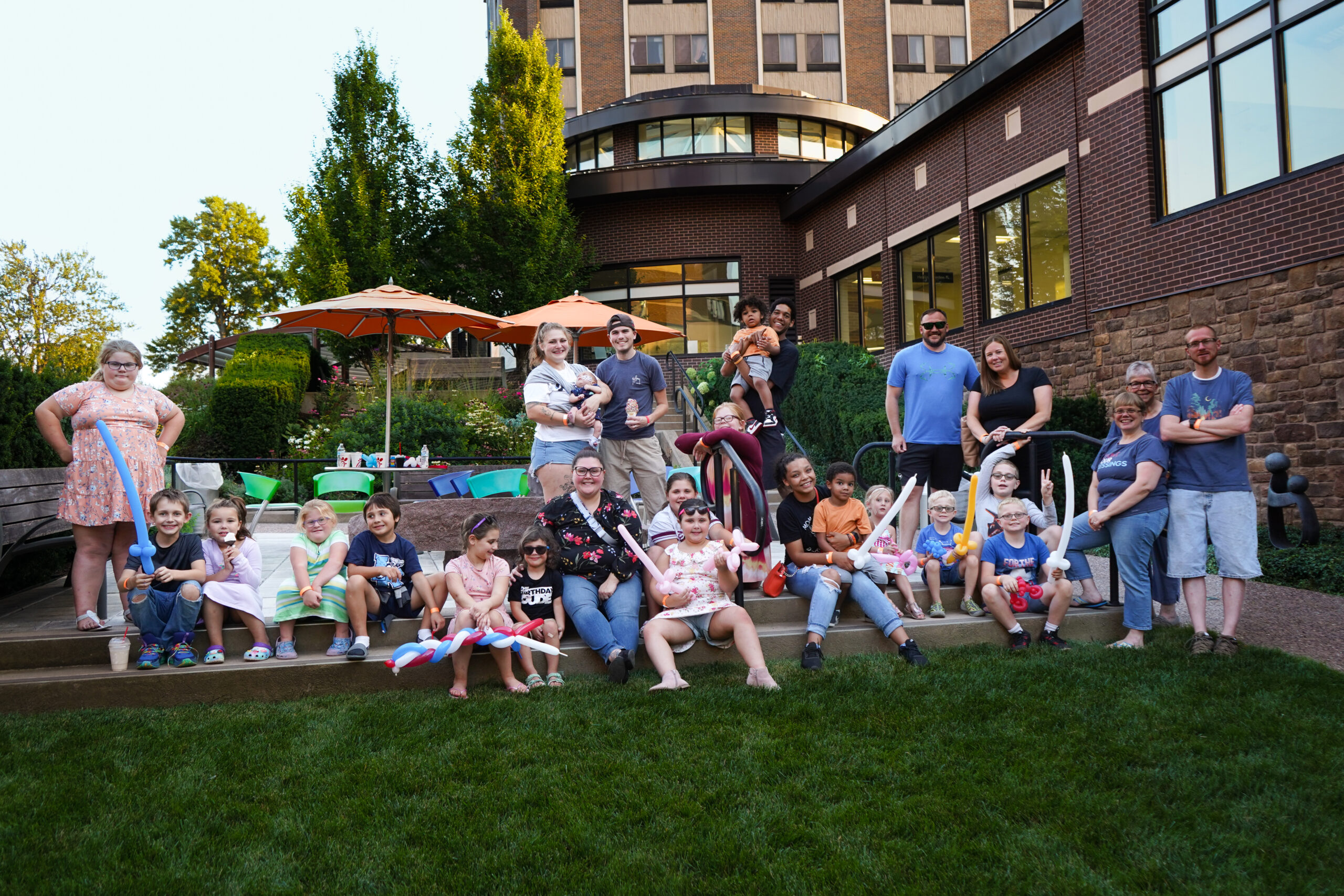 NNY Children's Miracle Network families. They are posing at the Healing Gardens at Samaritan Medical Center. 