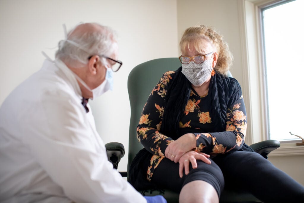 Wound Care Center image: doctor interacting with patient.