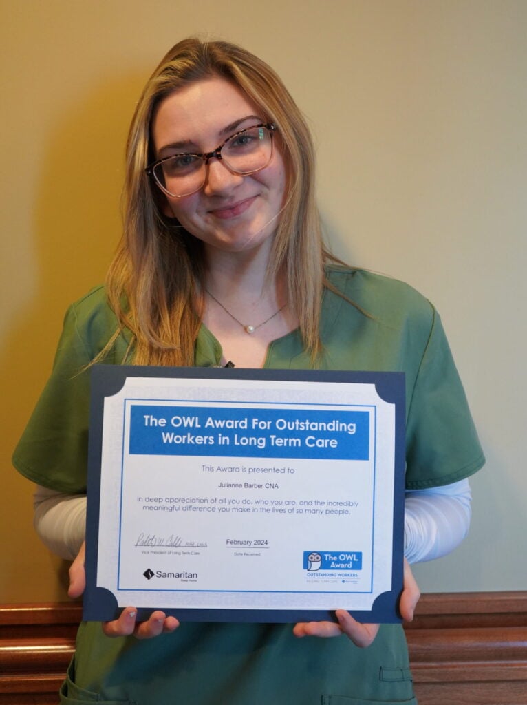 Julianna Barber's portrait holding her OWL Award certificate. 