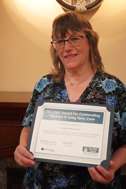 Portrait of Suzanne Kirkpatrick holding her OWL Award certificate