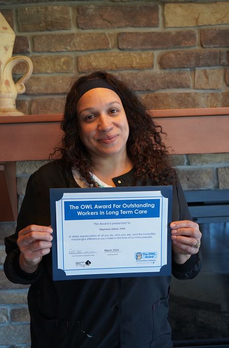 Portrait of Stephanie Deline holding her OWL Award certificate