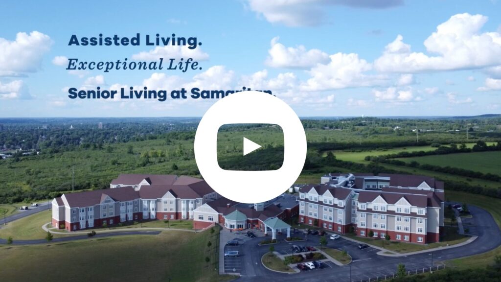 YouTube thumbnail: Samaritan Summit Village picture. Play button in the center.