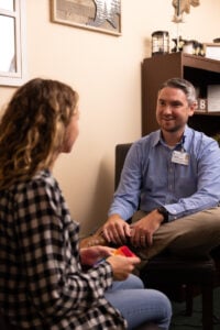 Image shows a therapist during session with a young patient. 