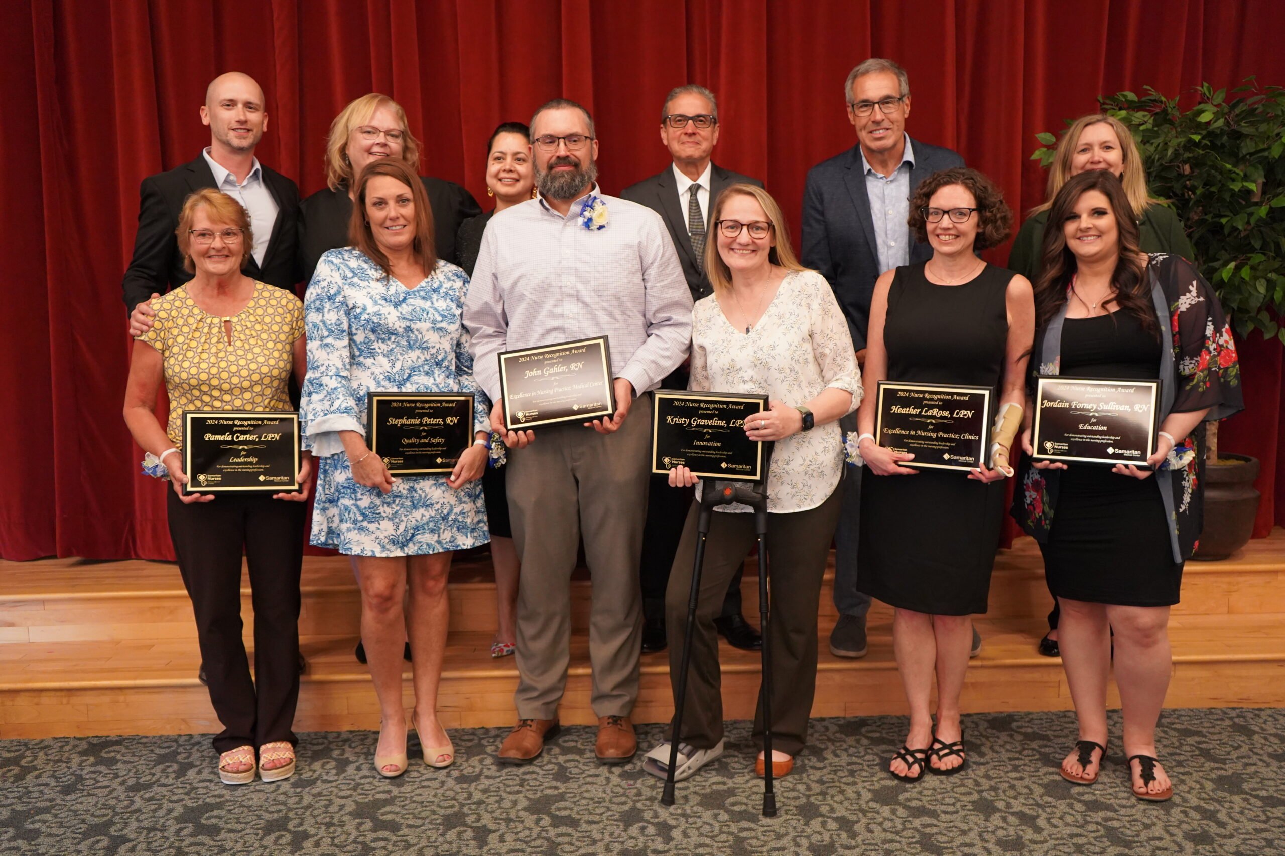 Pictured here, in front, from left are Pamela Carter, LPN, Stephanie Peters, RN, John Gahler, RN, Kristy Graveline, LPN, Heather LaRose, LPN, and Jordain Forney Sullivan, RN. In back, from left are Nathanial Miletta, MD, Rory Sears, DO, Aaliya Burza, MD, Mario Victoria, MD, Joe Wetterhahn, MD, and Stephanie Droppelmann, MSN, BSN. Absent from the photo are Kasandra Keene, RN, Emily Bachmann, LPN, and nominators Collins Kellogg, MD, and Maja Lundborg-Gray, MD