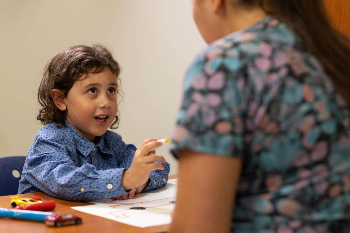 Child is looking at the provider during an occupational therapy session.