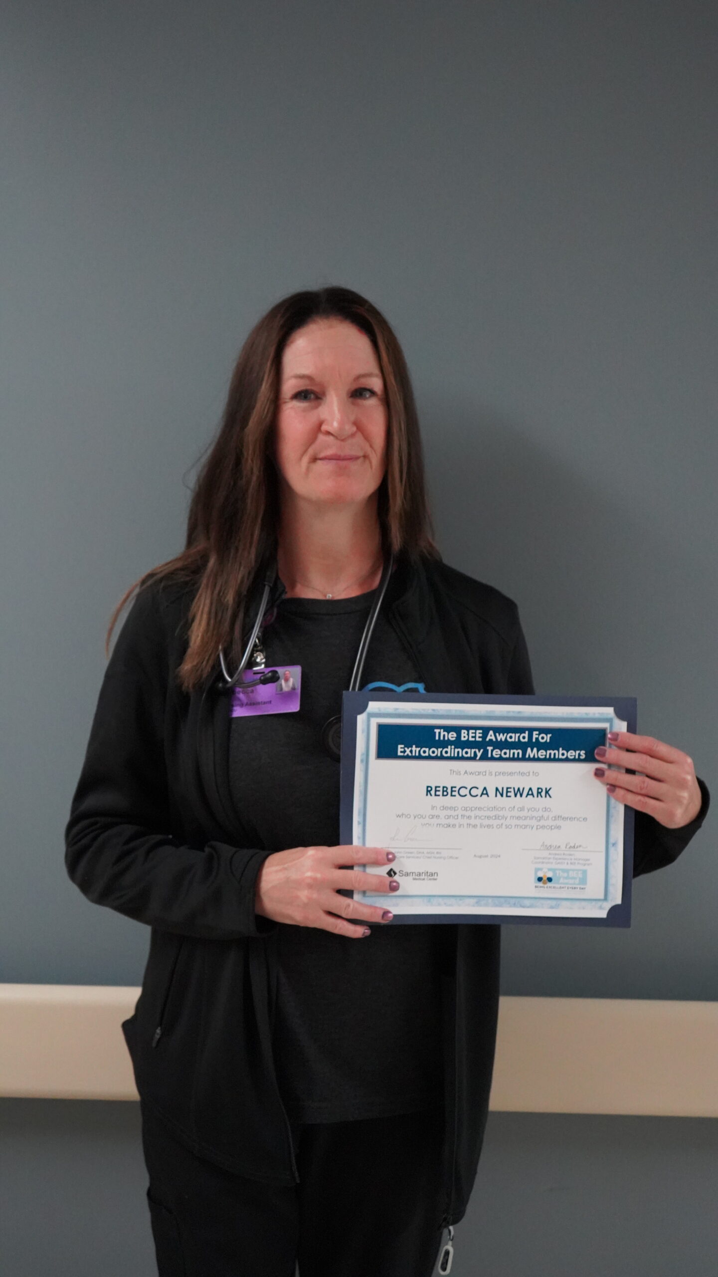 Rebecca Newark, NA, holding her BEE Award certificate