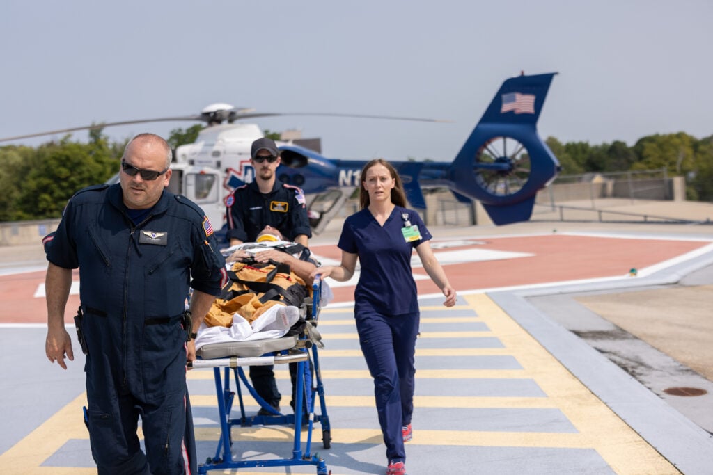 Trauma team meets a LifeNet Helicopter to receive a patient