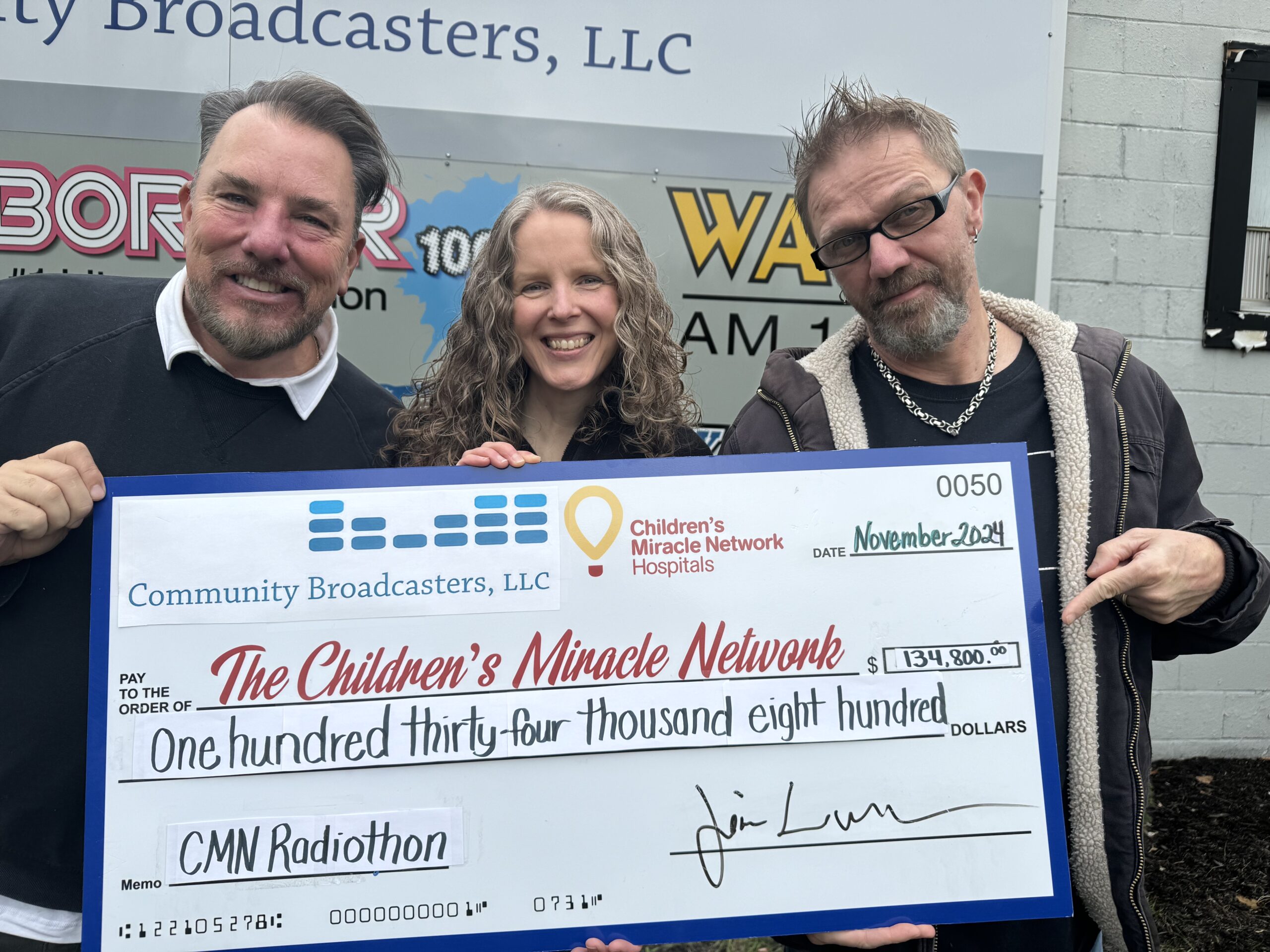 Radiothon check presentation to Children's Miracle Network. The photo shows Jhonny Spezanno, from the Border radio station, Angie VanWormer, CMN of NNY director, and Lance, from 94 Rock radio station, holding the $134,800 check from the 2024 Radiothon campaing.