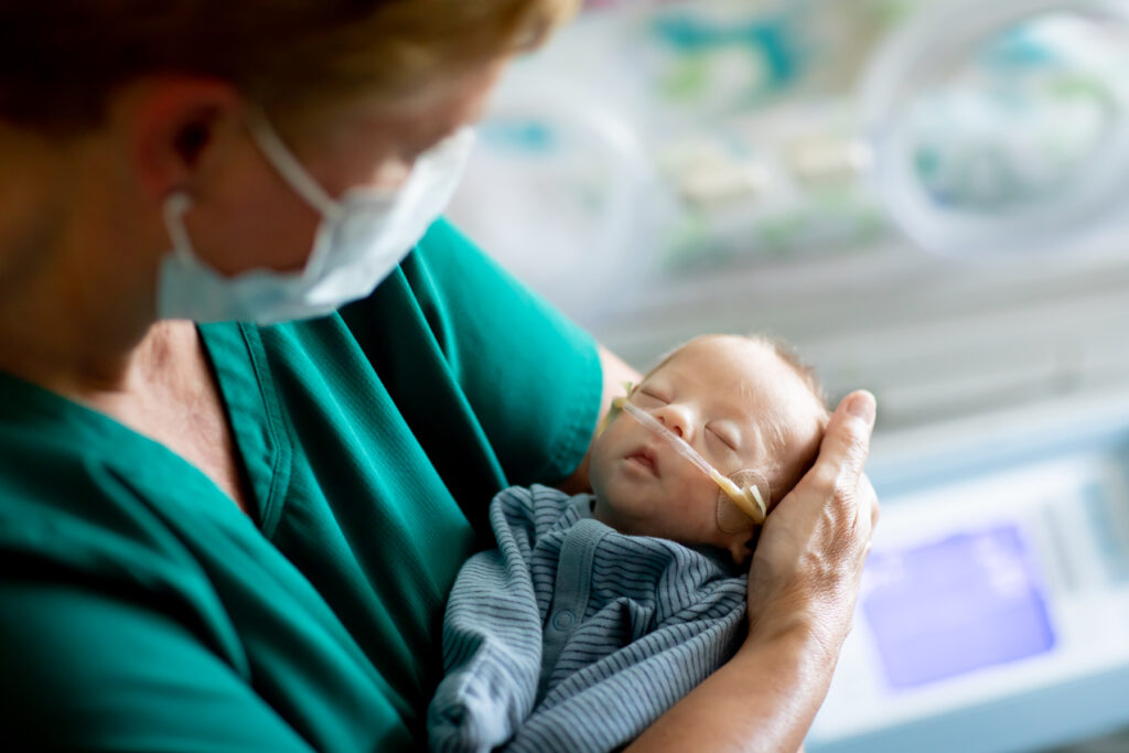 Nurse holding a NICU baby