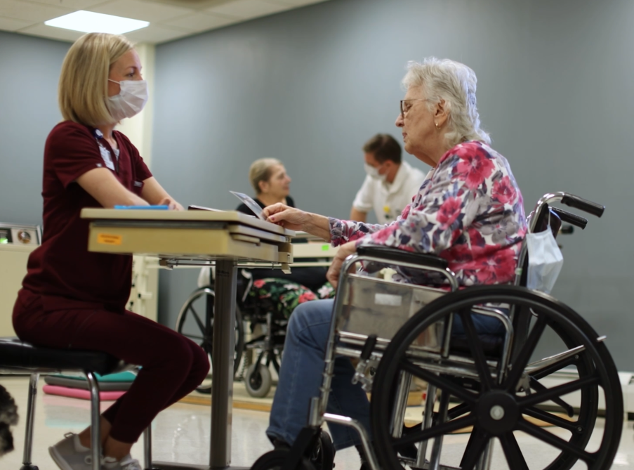 Photo of nurse and resident doing rehabilitation therapy