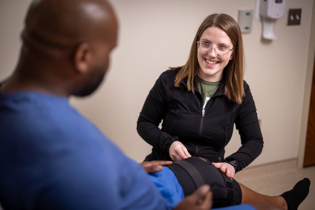 Medical Assistant helps a patient
