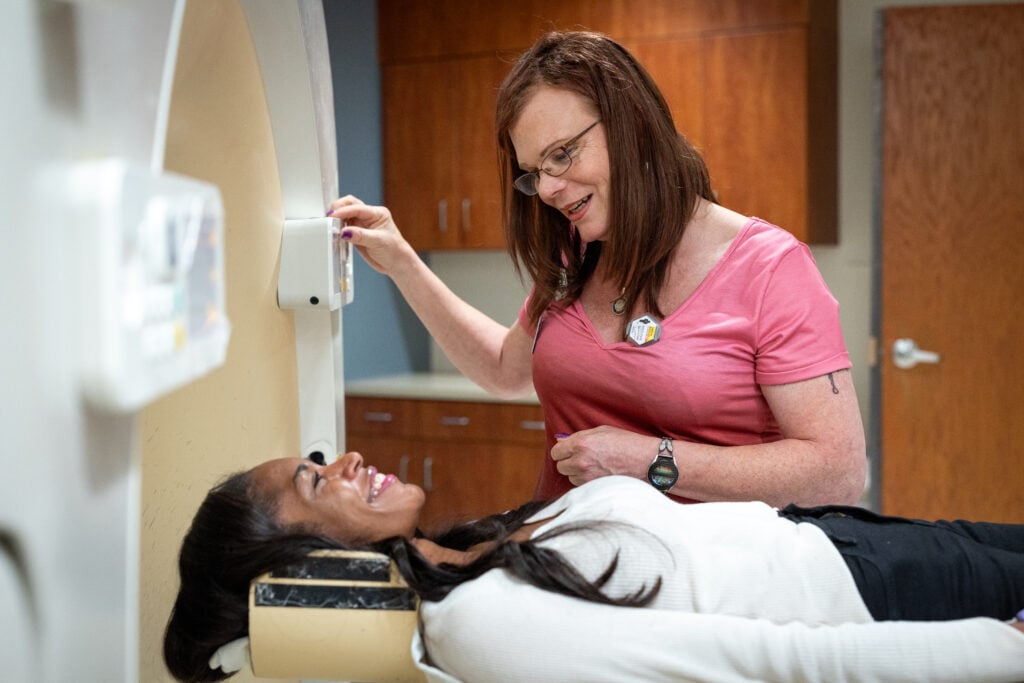 Photo of Stacie Monica, a CT Tech seeing a patient