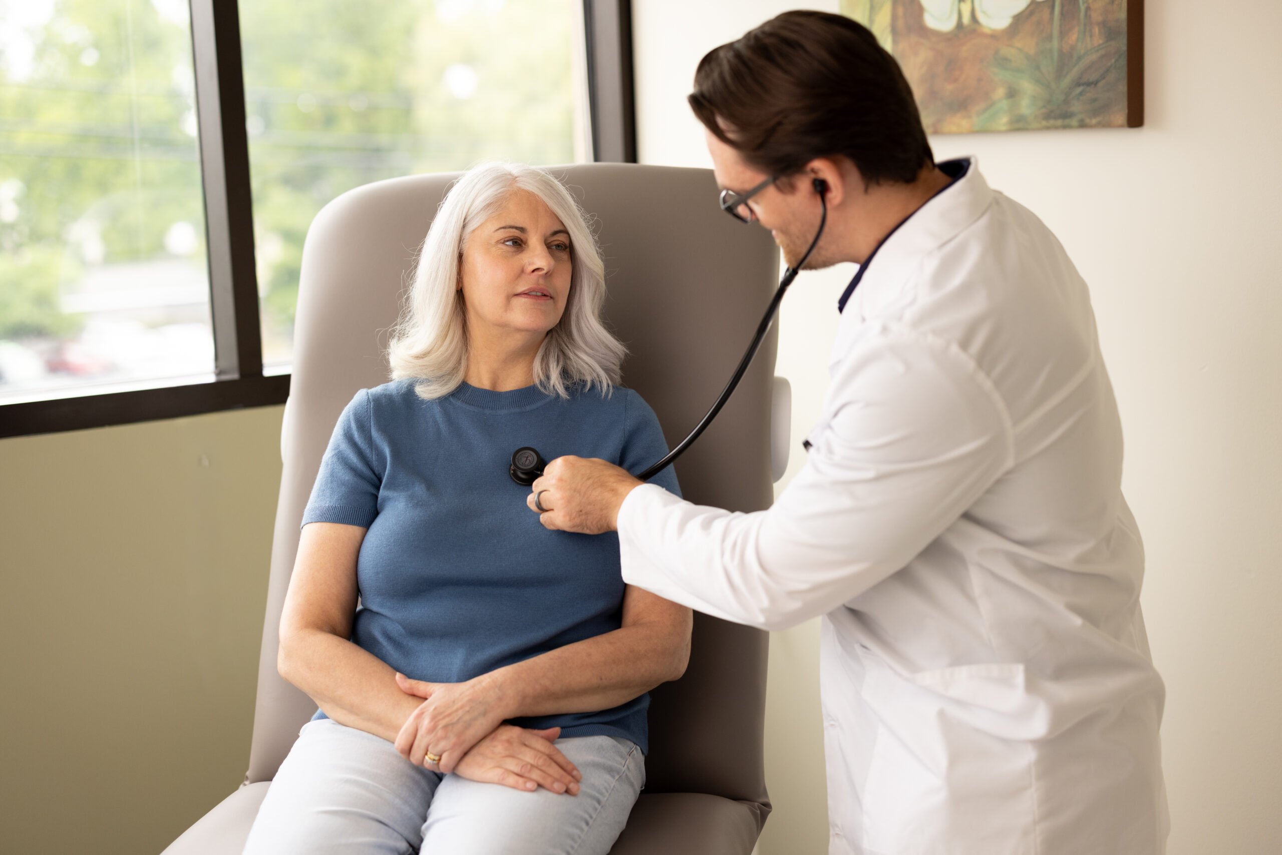 photo of Dr. Britton, LeRay primary care physician, performing a check-up on a patient