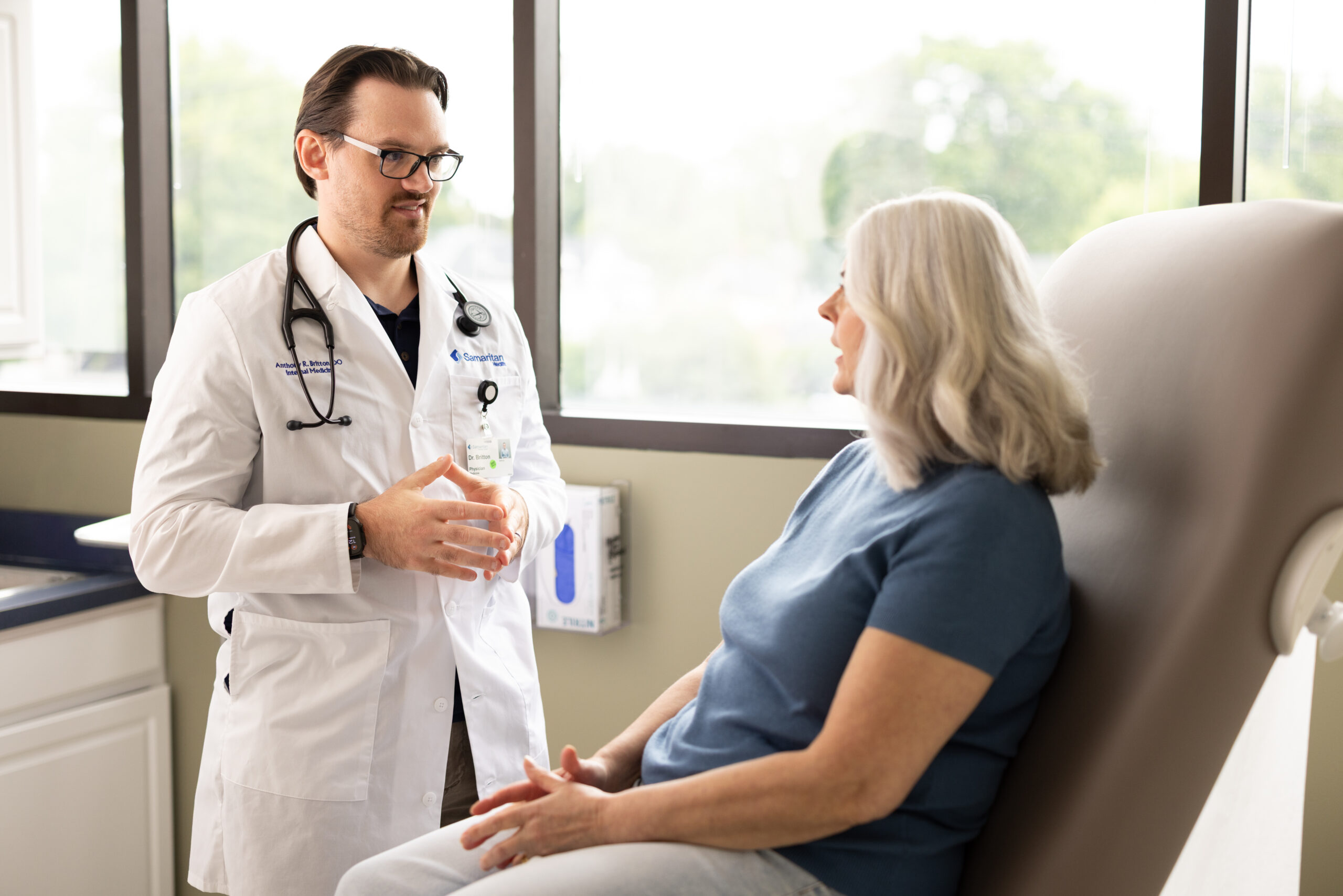 photo of Dr. Britton, LeRay primary care physician, performing a check-up on a patient