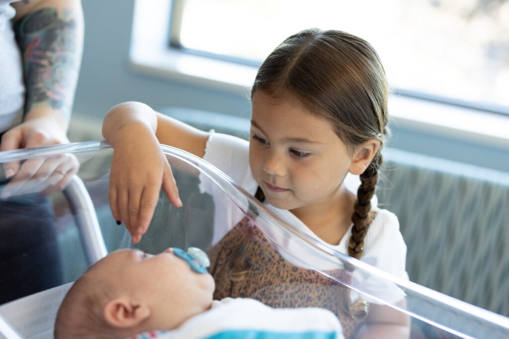 Photo of a sister and baby at the Car-Freshner Center for Women and Children