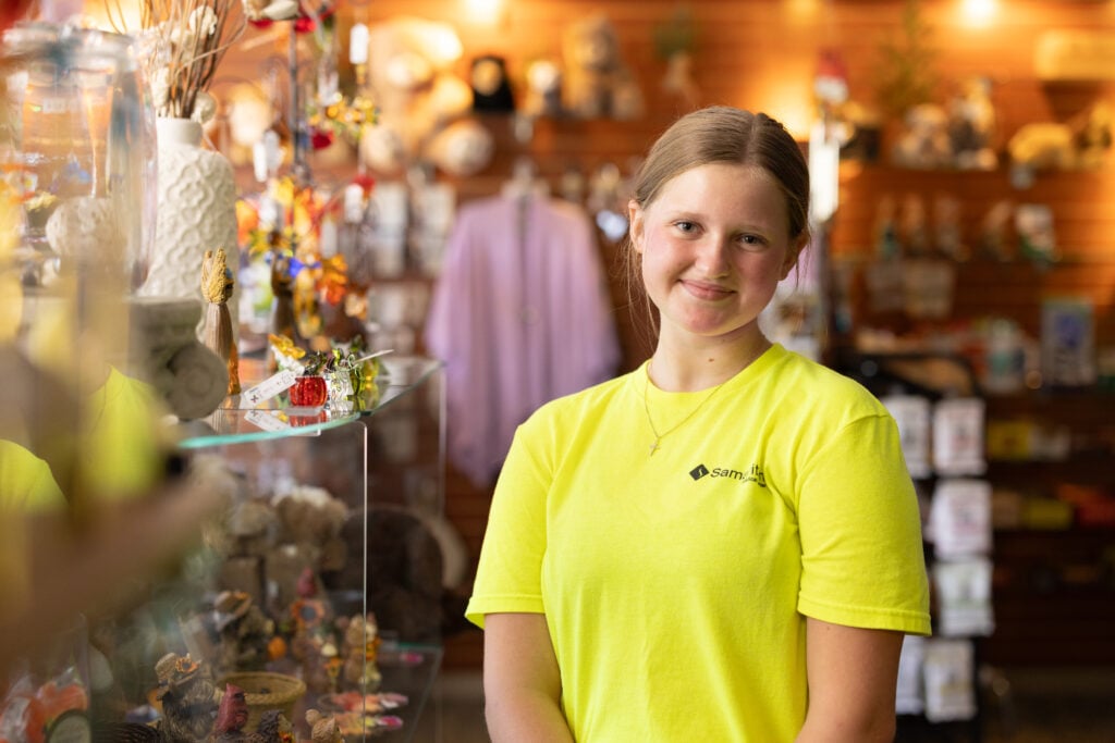 Photo of a female volunteer posing in the gift shop