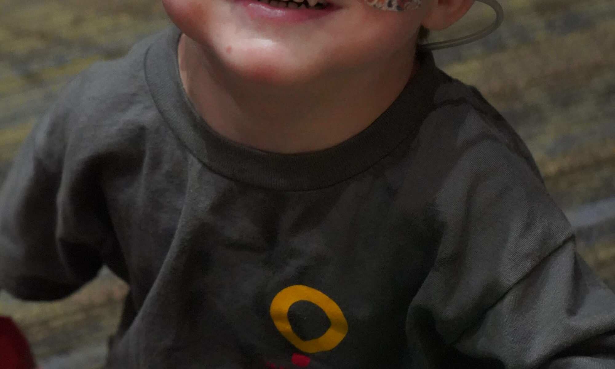 CMN kid Finley smiles with a balloon in his lap during the Radiothon