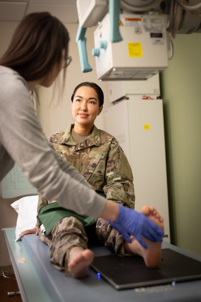 a female Military member gets an X-ray on her foot